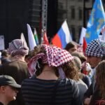 Demonstrators gather near Berlin’s Brandenburg Gate during a public protest.