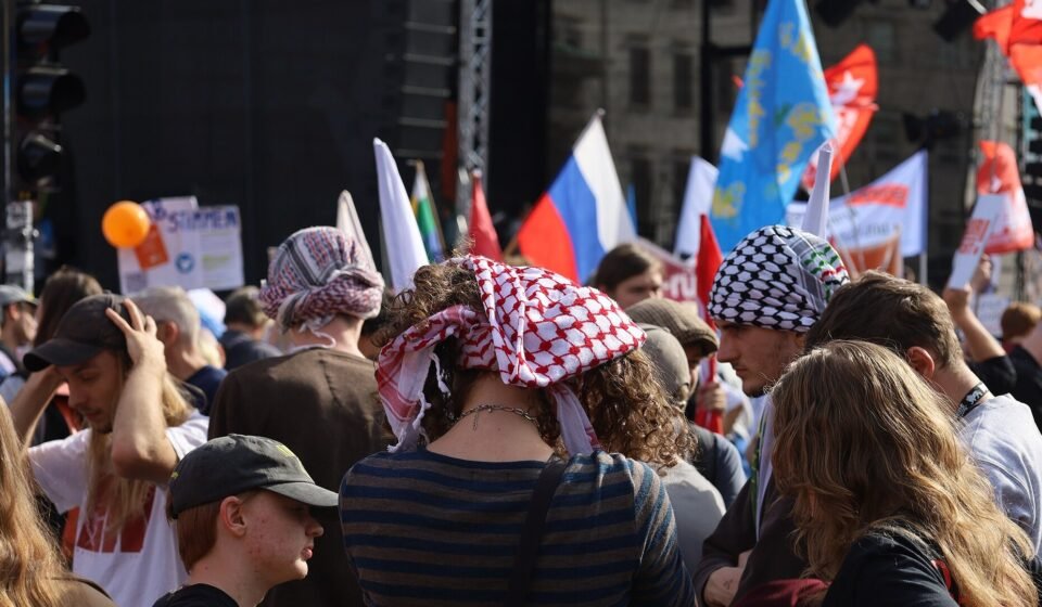Demonstrators gather near Berlin’s Brandenburg Gate during a public protest.