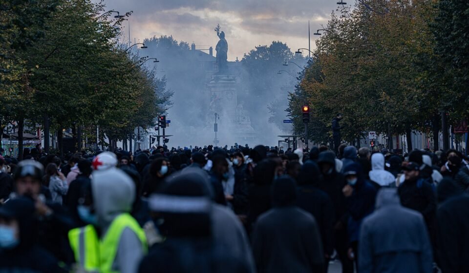 Paris Calms After Overnight Curfews as France Tightens Crackdown on Rioters Demonstrators gather amid tear gas at Place de la République in Paris during the October 17, 2026 unrest.
