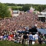 Barack Obama speaking at a campaign rally from a lectern.
