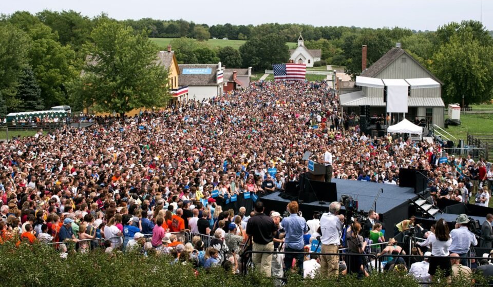 Barack Obama speaking at a campaign rally from a lectern.